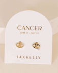 gold earrings in the shape of the cancer zodiac sign