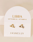 gold earrings in the shape of the libra zodiac sign