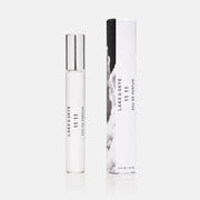 A clear travel spray bottle of perfume.