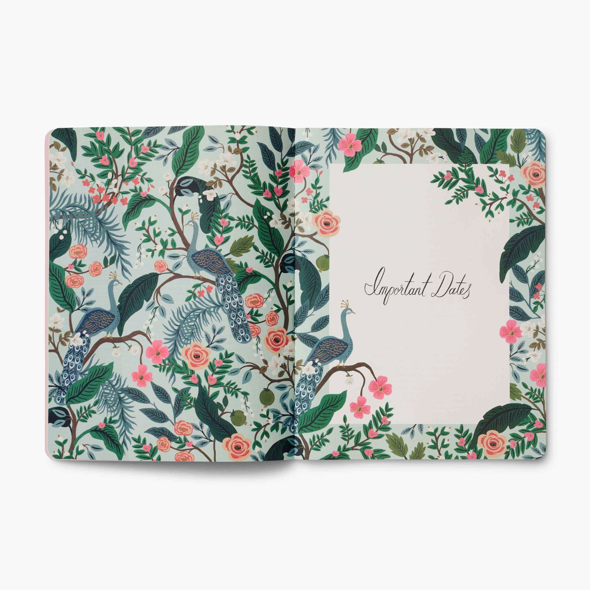 The inside of the planner open to a page featuring the same peacock and floral design along with a page that reads, &quot;Important Dates&quot; in black cursive. 