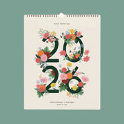 A 2026 calendar with a spiral bound top edge and '2026 Appointment Calendar' with flowers wrapped around the numbers.
