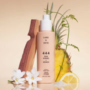 A peachy colored bottle of hair and body spray with black text that reads, 'Lake & Skye 444 Sun Kissed + Monoi'.