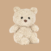 A light creamy tan bear shaped bear stuffed animal toy.
