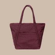 A mahogany, burgundy red nylon puffer tote.