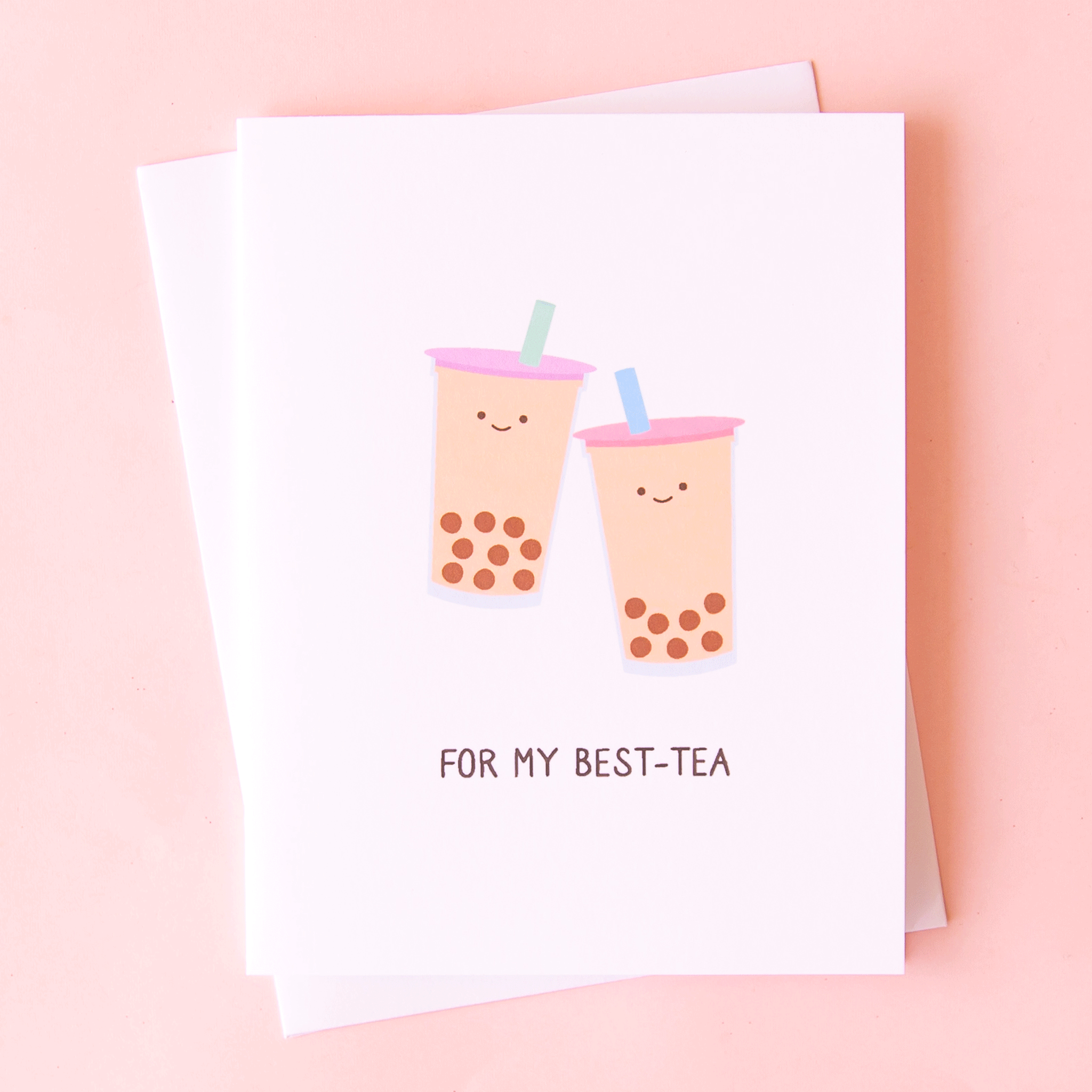 A white card with illustrations of two bubble teas, both with smiling faces and text underneath that reads, &quot;For My Best-Tea&quot; in black letters.