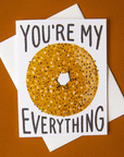 Idlewild Everything Bagel Folded Card - featuring a photograph of a white folded card with a graphic of an everything bagel along with "You're My Everything" in black text.