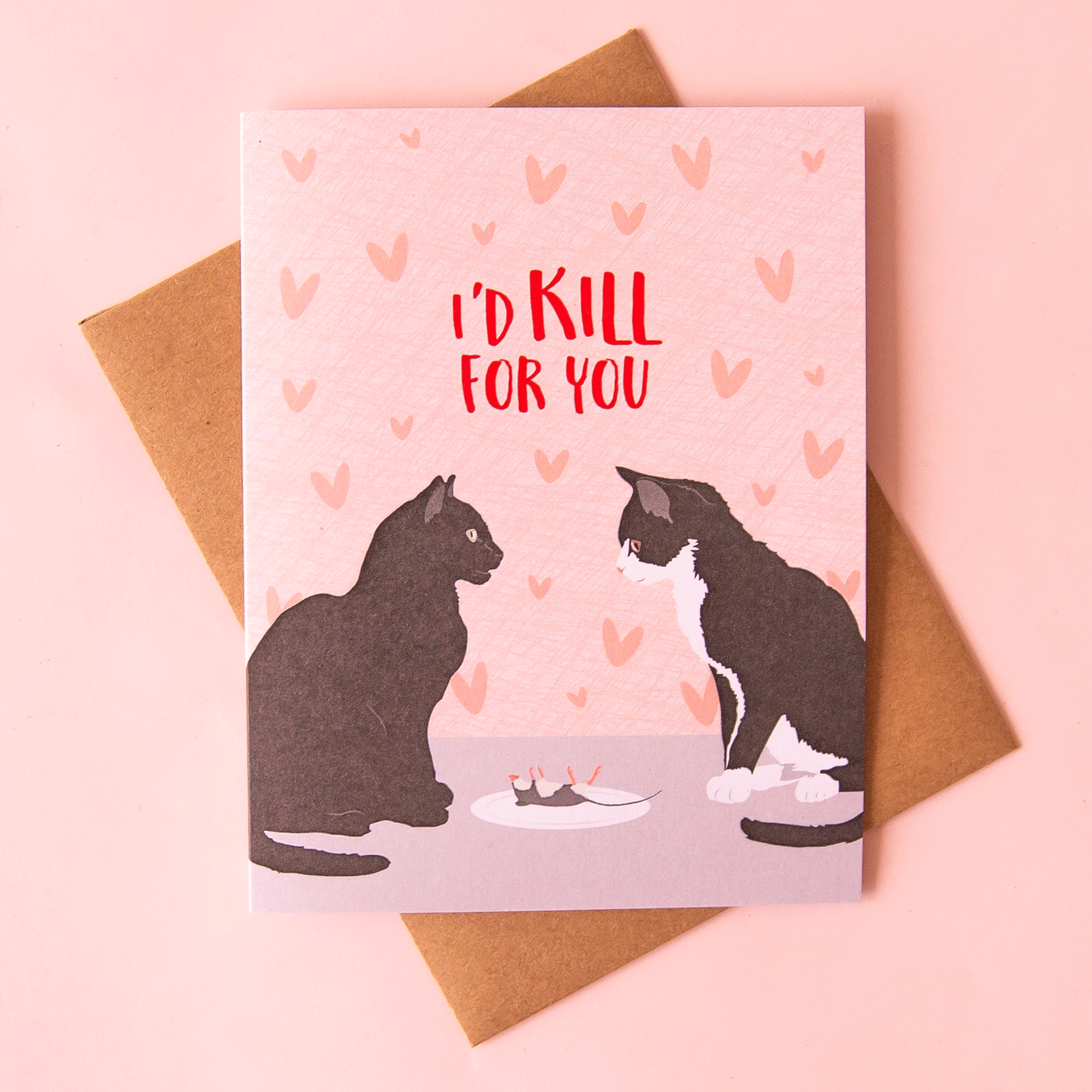 On a pink background is a pink card with an illustration of two black cats looking at each other with a plate in between that has a dead mouse on it. There is text above the illustration that reads, &quot;I&#39;d Kill For You&quot; in red letters. 