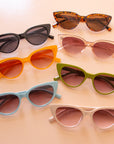 All the colorways of the Frenchie sunglasses lined up in a photo.