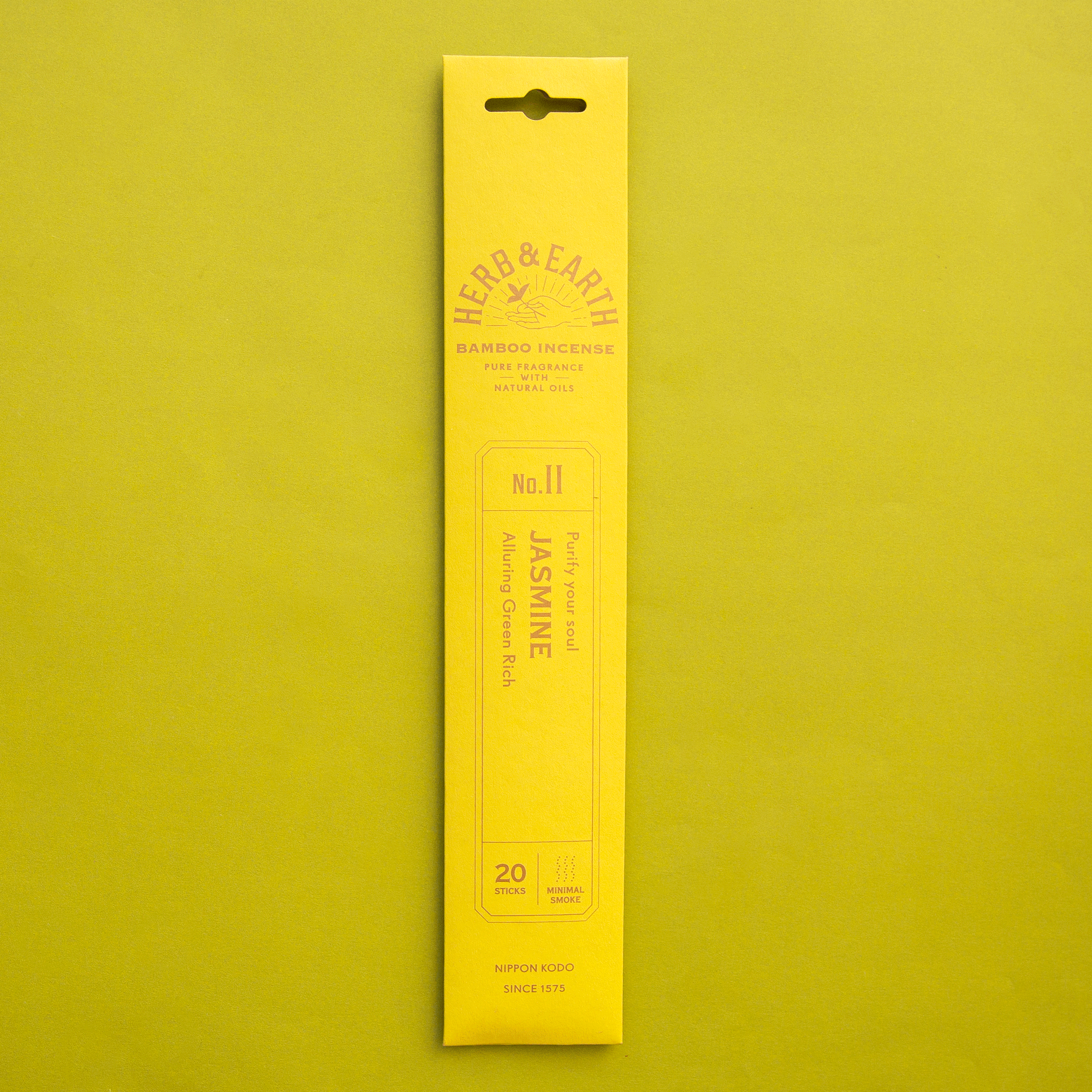 On a chartreuse background is a yellow package of Jasmine scented incense. 