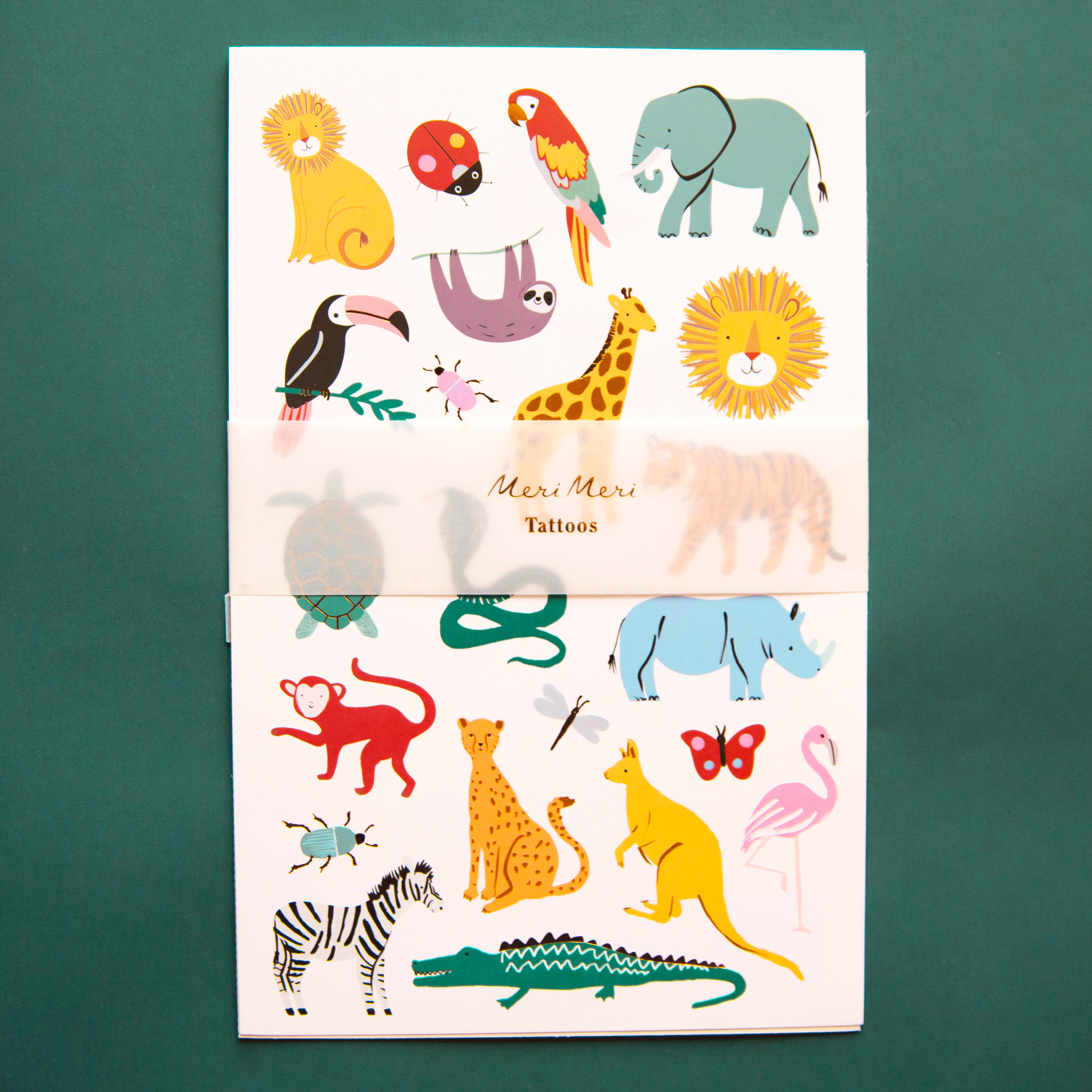 On a green background is a white sheet of temporary tattoos with different animal shapes. 