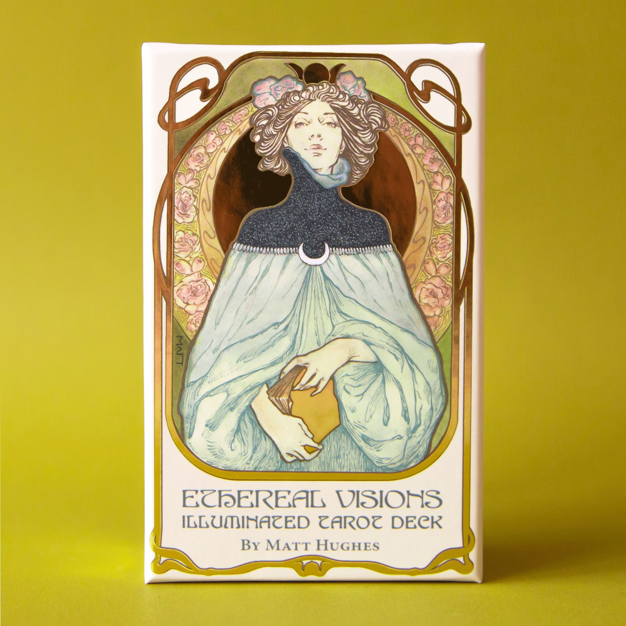 On a green background is a deck of cards with a person illustrated on the front holding a book and text underneath that reads, &quot;Ethereal Visions Illuminated Tarot Deck&quot;. 