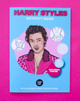 A blue coloring book with a graphic of Harry Styles in a pink polka dot suit along with pink text on the top that reads, "Harry Styles Activity Book".