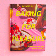On a pink background is a hot pink book cover with desserts on the front and yellow text that reads, "Baking For Pleasure".