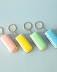 On a blue background is four VW bus shaped keychains in pink, yellow, green and blue. Each color sold separately.