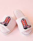 Pink fuzzy slide slippers with an open toe front and a pink and red cowgirl boot graphic on the top.