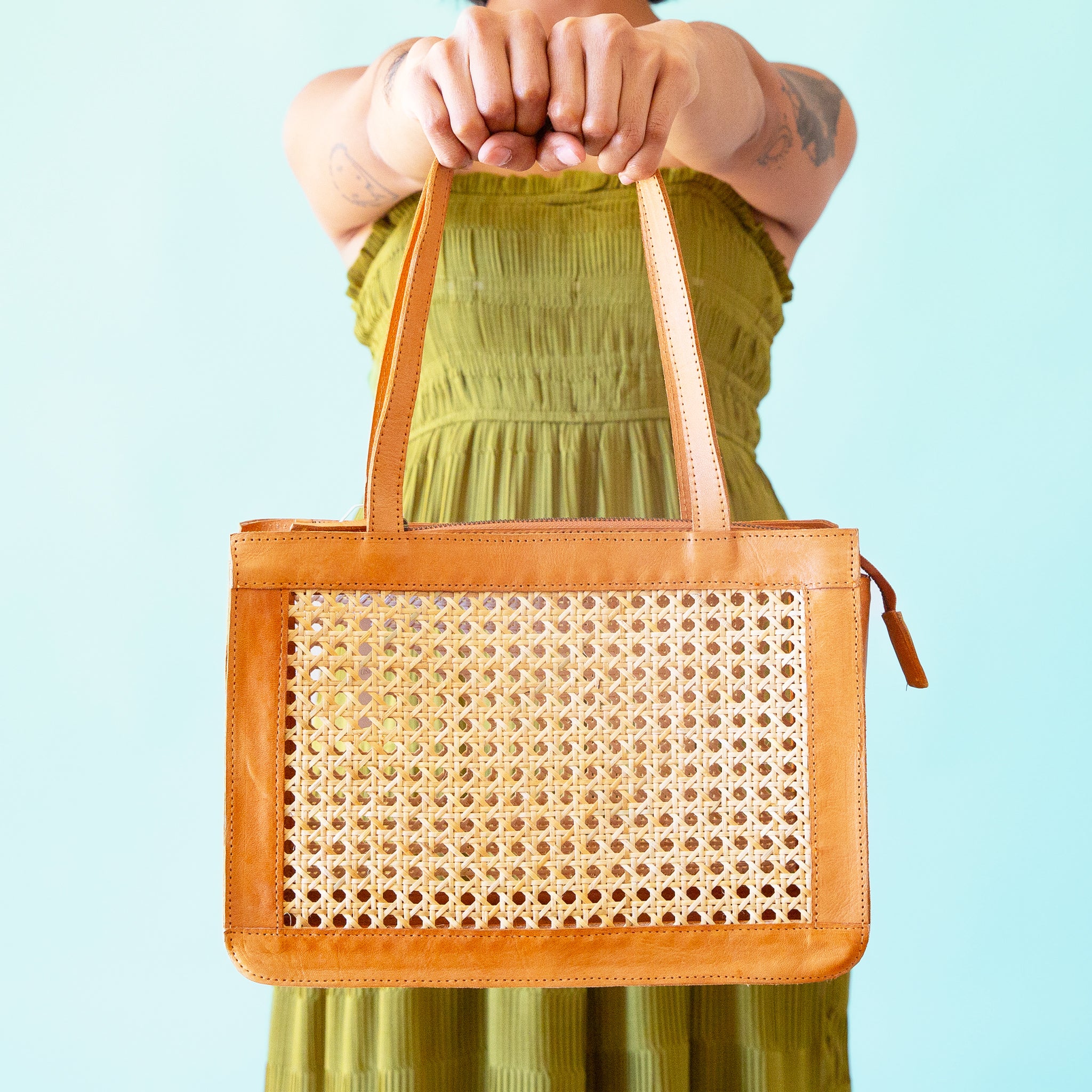 A leather and rattan cane handbag. 