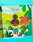 A vibrantly illustrated book opened to a page with illustrations of the main character Punky with a skateboard and text above that reads, "Hi, I'm Pinky! Punky Aloha.".
