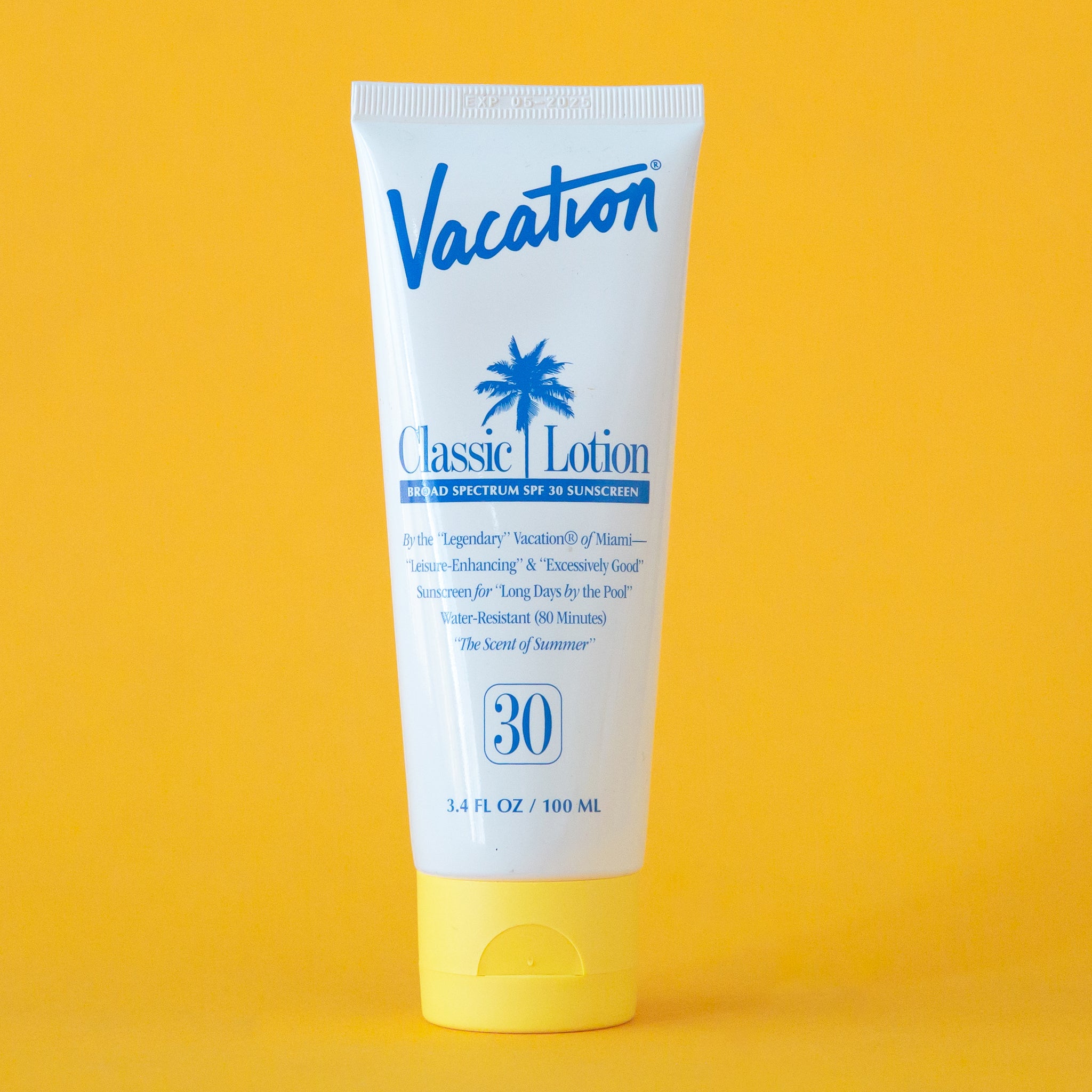 On a yellow background is a white squeeze tube of sunscreen with a yellow lid and a blue text that reads, &quot;Vacation Classic Lotion SPF 30&quot; along with a blue palm design in the center.