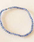 On a neutral background is a blue beaded Sapphire bracelet.