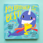 A blue book cover with a whale on the front holding a trophy and the title that reads,"My Brother Is The Best!".