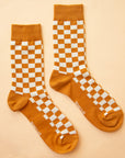 A burnt orange and white checker print pair of socks.