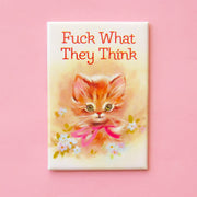 On a pink background is a magnet with an illustration of a kitten and florals around it and text above that reads, "Fuck What They Think".
