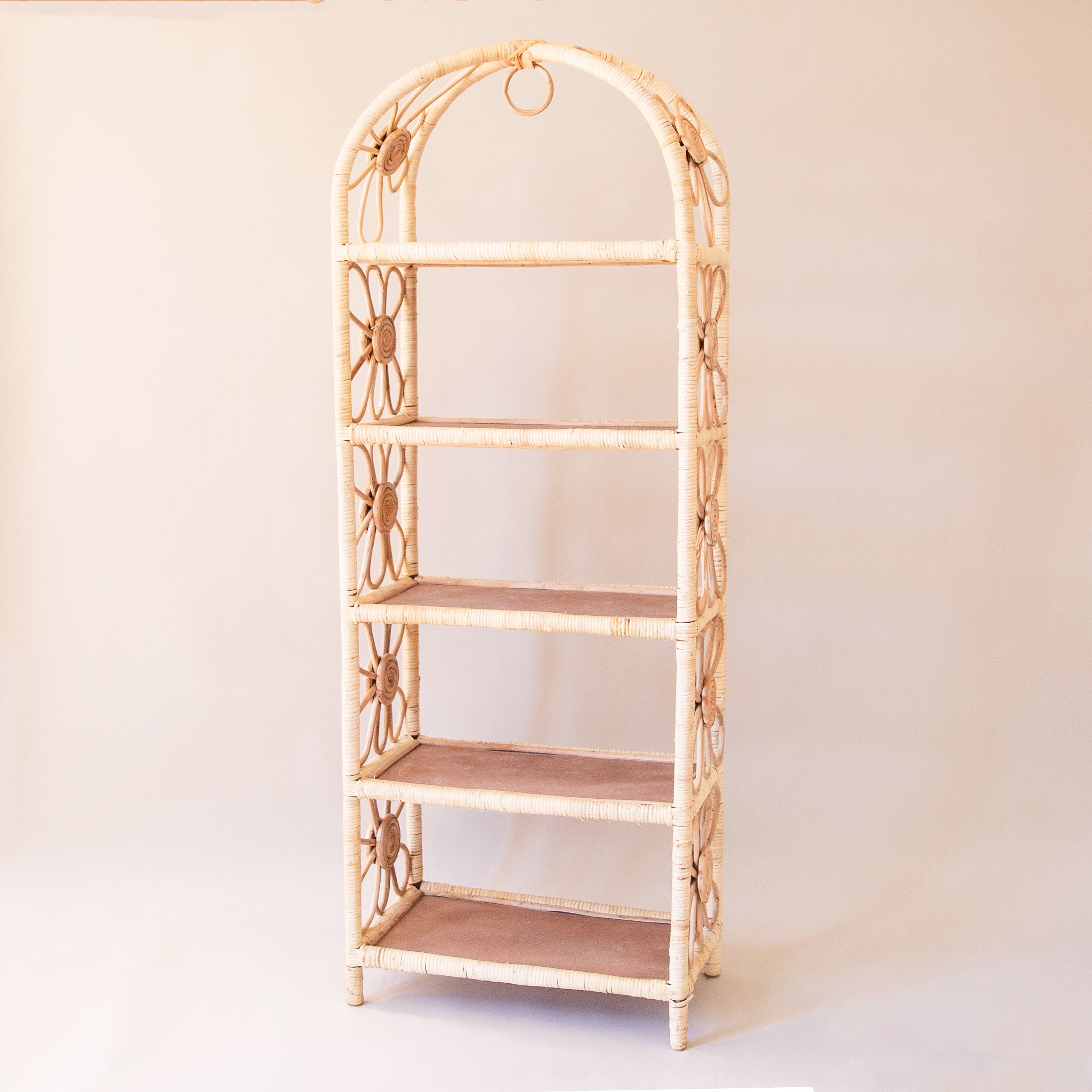 The large version of the shelf. Natural woven rattan shelf with daisy accents on both sides. The sides are open and let in ample light to keep the shelves well lit. Each shelf is covered in rattan and has a chocolate brown bottom