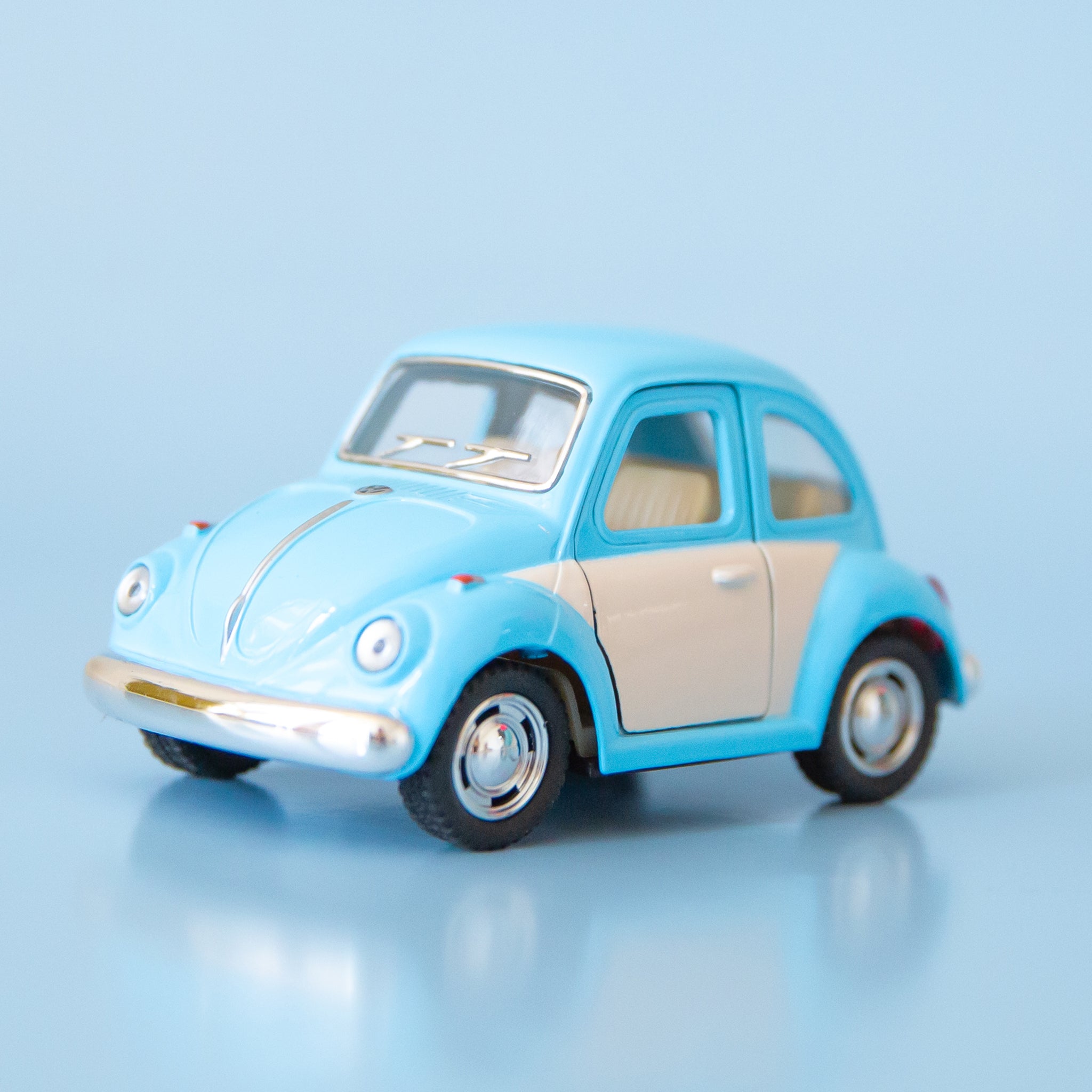 A blue and white metal toy car volkswagen beetle.