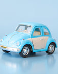 A blue and white metal toy car volkswagen beetle.