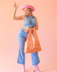 A nylon reusable bag with a cowgirl boot pattern.