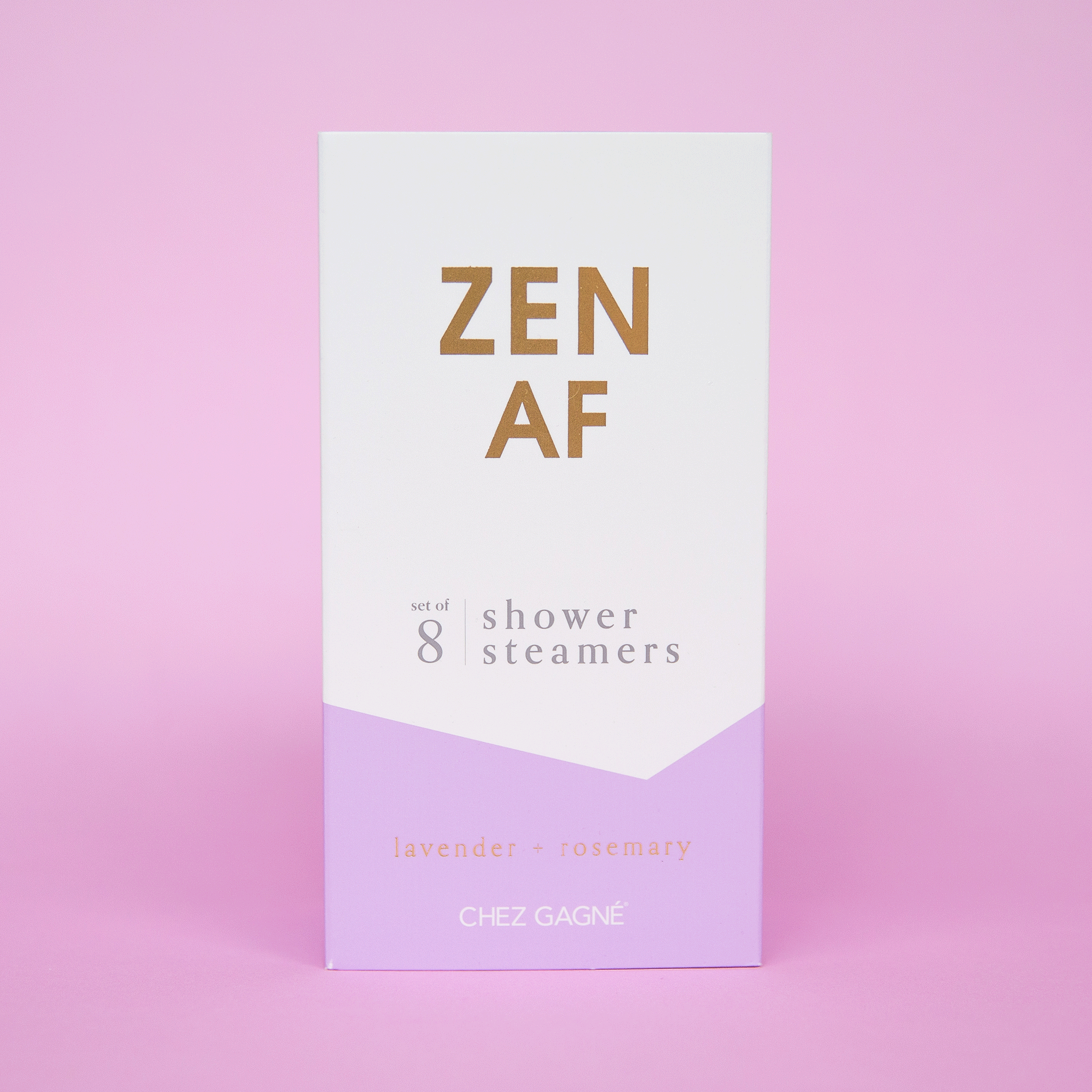 Eight lilac purple shower steamer tablets inside of a purple and white box that reads, &quot;Zen AF&quot; in gold text across the front.