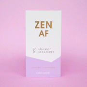 Eight lilac purple shower steamer tablets inside of a purple and white box that reads, "Zen AF" in gold text across the front.