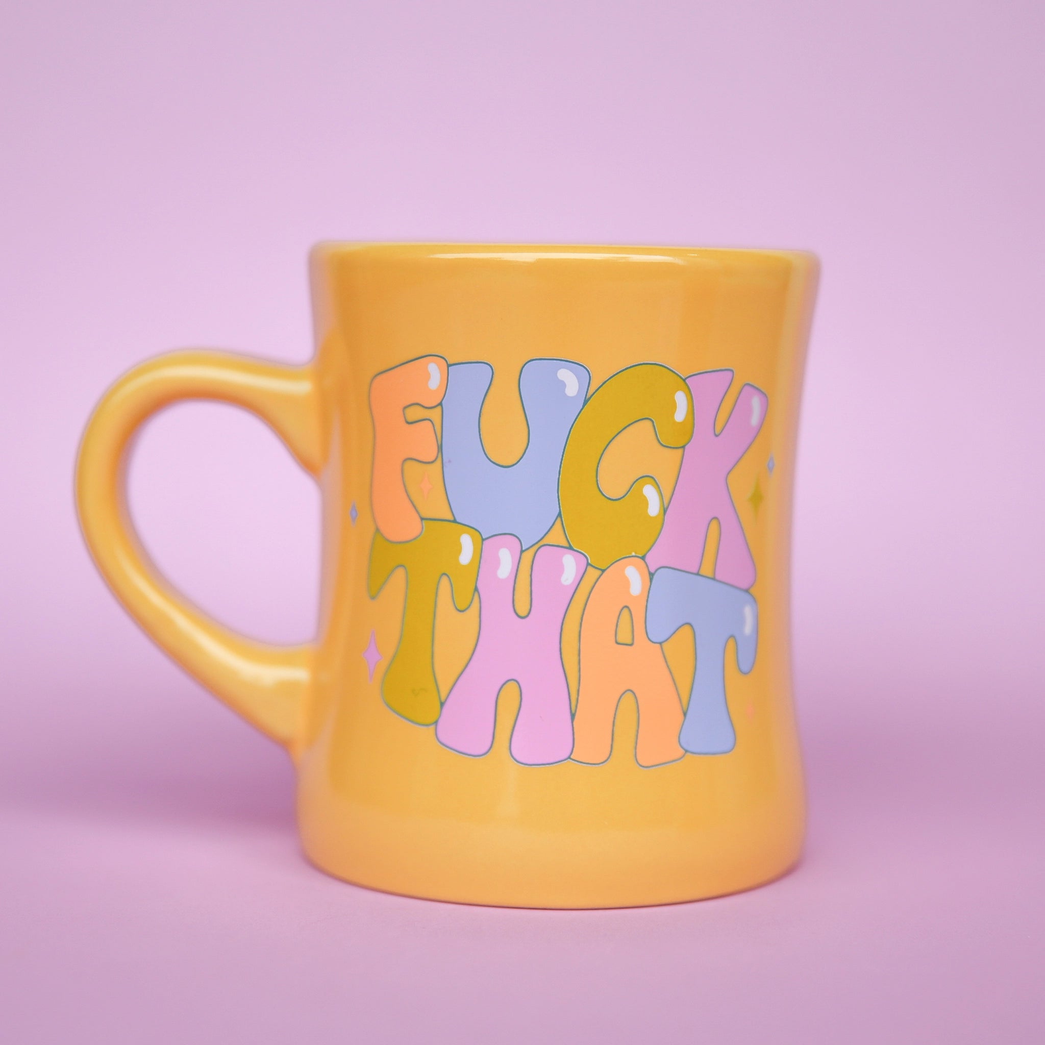 On a purple background is a yellow diner style mug that reads, "Fuck That" in multi colored text.
