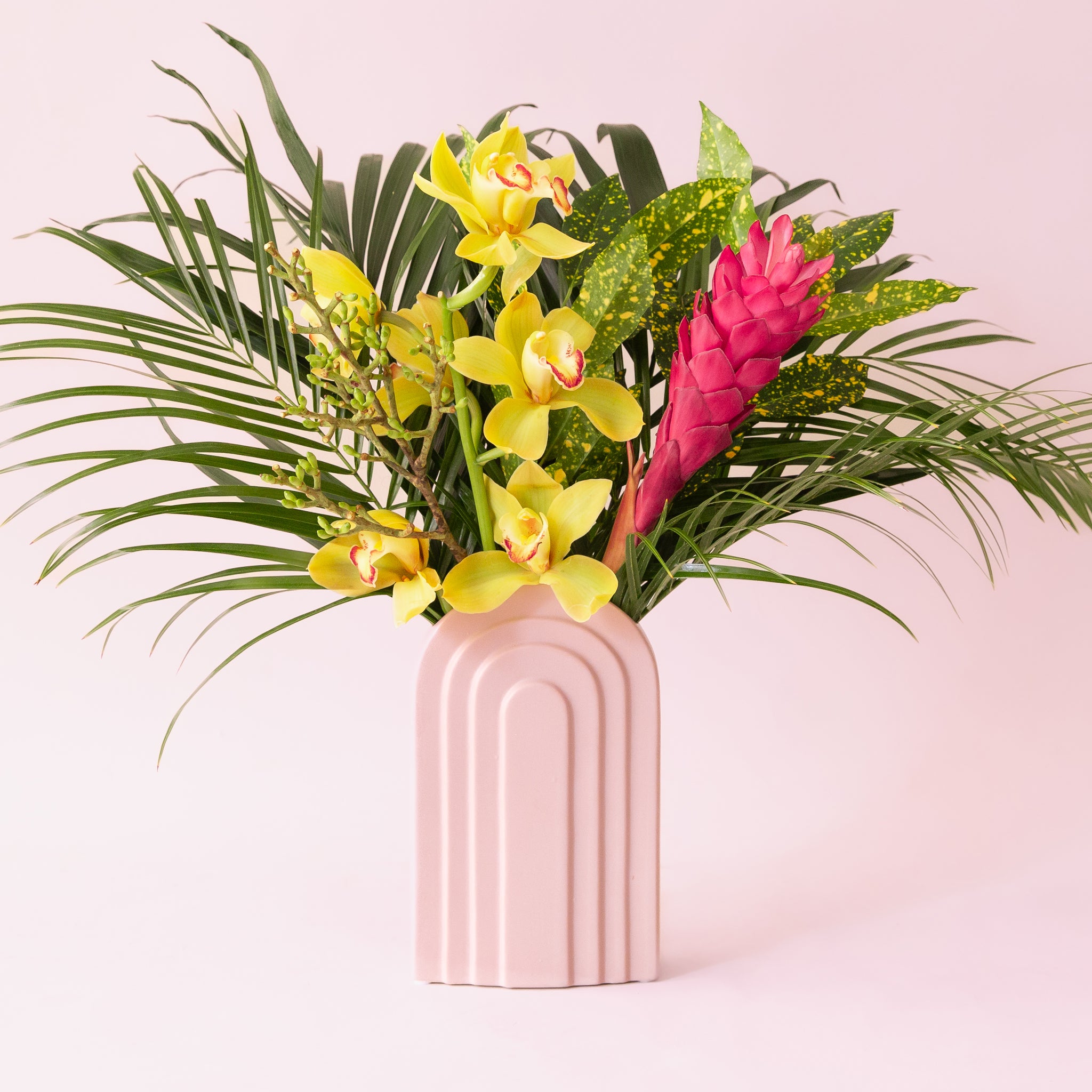 An arched ceramic vase in a cool toned pink shade.