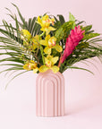 An arched ceramic vase in a cool toned pink shade.