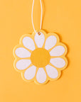 A yellow, white and orange daisy shaped air freshener
