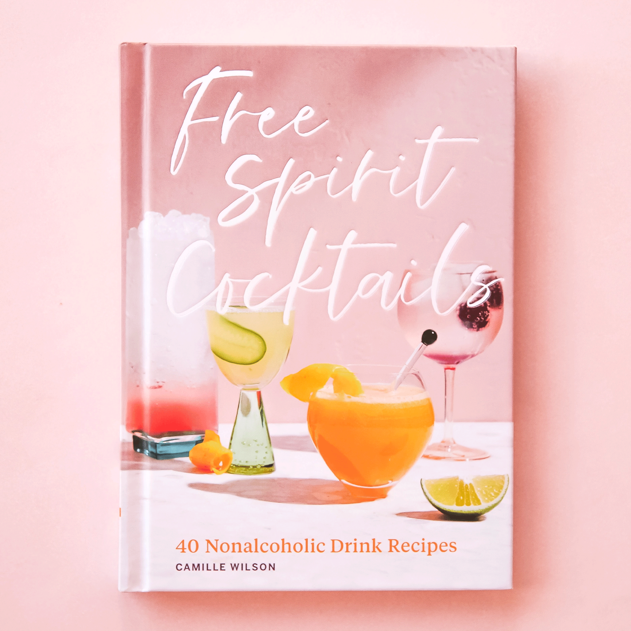 A mauve front cover with various cocktails and and the title &quot;Free Spirit Cocktails, 40 Nonalcoholic Drink Recipes&quot;.