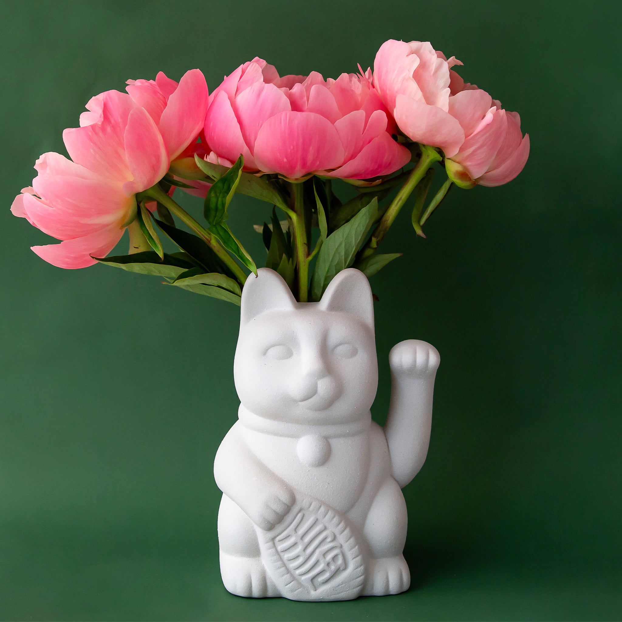 A ceramic lucky cat vase in white with its paw up in the waving position staged here with natural dried florals.