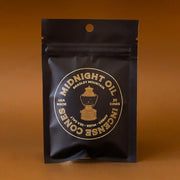 On a brown background is a brown package of incense cones.