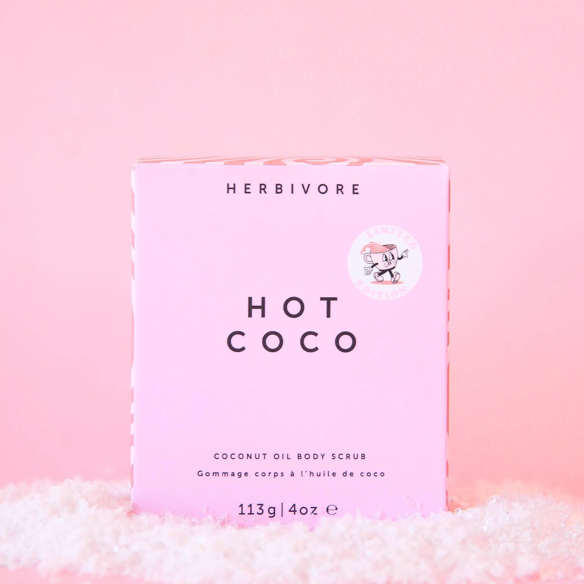 On a pink background is a pink box that reads, &quot;Hot Coco, Coconut Oil Body Scrub&quot;.