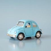 On a blue background is a blue vw bug toy.