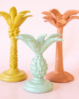 Three pineapple palm tree shaped taper candle holders in mint, yellow and clay.