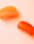 A two-toned rounded claw clip in shades of orange.