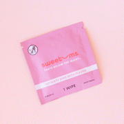 On a light pink background is a hot pink packet of a feminine wipes with text on the front that reads, "sweetums taste below the waist intimate wipe with flavor".