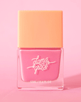 On a pink background is a square nail polish bottle with a bright pink nail polish inside