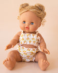 A two piece yellow and ivory swim suit on a Minikane doll. Dolls sold separately.