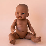 A baby girl doll with light brown eyes.