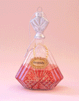 A glass decanter ornament with a gold label that reads, "Brandy" along with a pinkish base. The stopper to the decanter is silver and detailed with glitter.