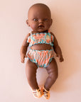 A coral and blue two piece swim suit for Minikane dolls. Dolls sold separately.