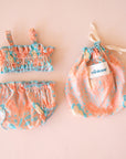 A coral and blue two piece swim suit for Minikane dolls. Dolls sold separately.